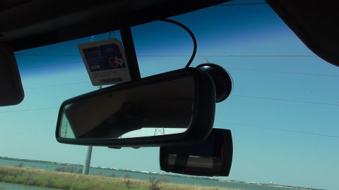 1996 Ford Bronco - View from inside a vehicle, showing the rearview mirror and a dashcam.