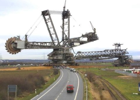 1992 Ford Bronco - A massive bucket-wheel excavator dominates the landscape, with a road and a few vehicles passing by.