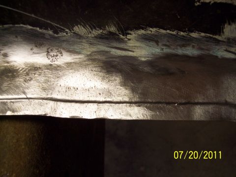 1973 Ford F-250 - A close-up view of a metal surface showing scratches and a distinct horizontal seam, with a date and website overlay.