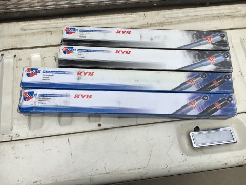 1988 Ford Bronco - Four boxes of Carquest KYB Performance Plus shock absorbers are shown in the bed of a vehicle.
