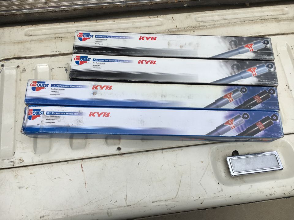 Four boxes of Carquest KYB Performance Plus shock absorbers stacked in a truck bed