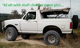 1992 Ford Bronco - This 1992 Ford Bronco is equipped with a soft top and off-road tires, seen from a three-quarter front angle.