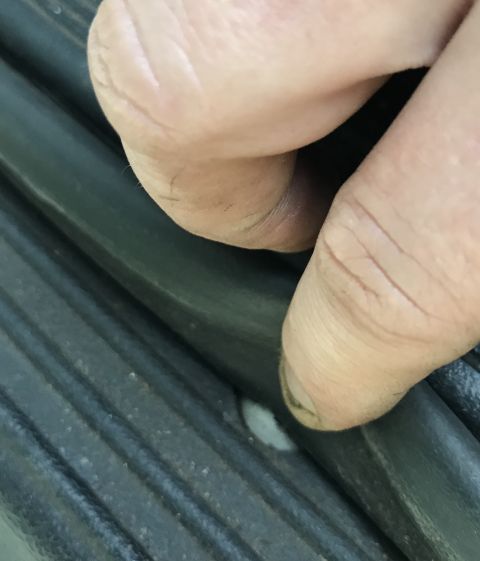 1995 Ford Bronco - Close-up of fingers interacting with a textured, ribbed surface, with a website watermark visible.