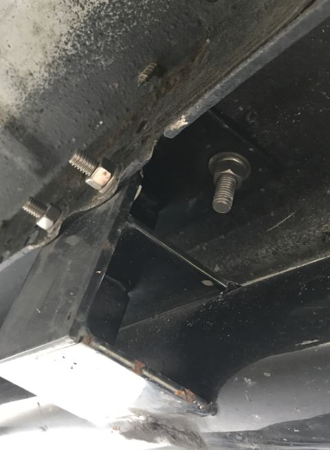 1995 Ford Bronco - Underside view of vehicle frame showing rust and bolted connections.