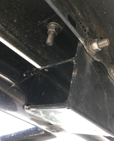 1995 Ford Bronco - The photo shows a close-up view of the vehicle's frame with visible bolts and mounting brackets.