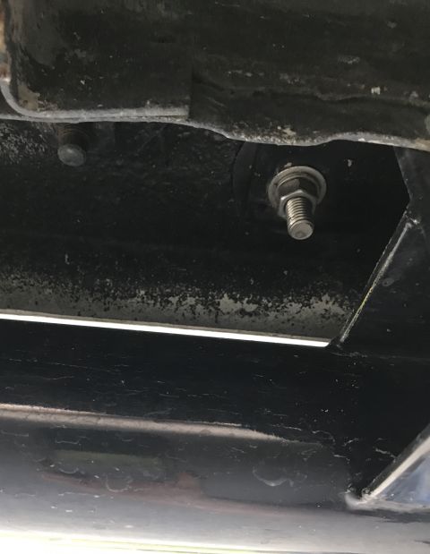 1995 Ford Bronco - Close-up view of a bolt and frame on the underside of a vehicle.