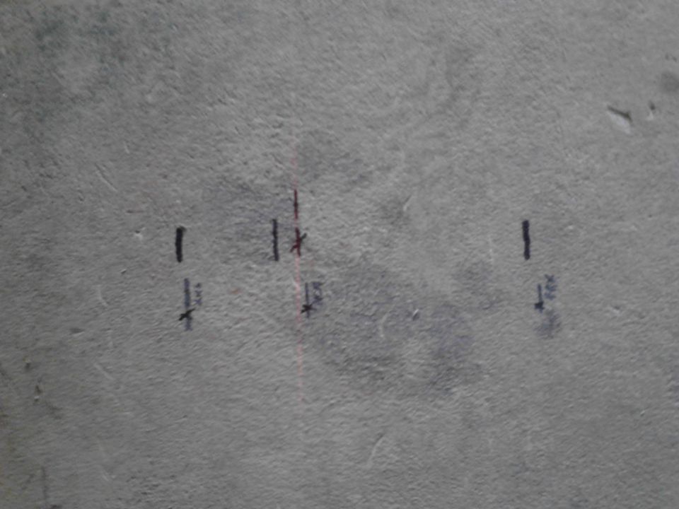 Gray surface with black and red marks, including lines and asterisks