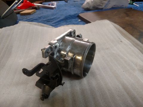 1995 Mercury Grand Marquis - Throttle body assembly with linkage, likely for an older vehicle.