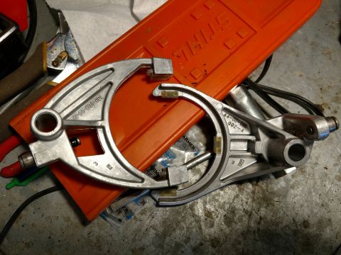 1992 Ford Bronco - Two metal transfer case components are laid out on a workbench, with part numbers visible on each.