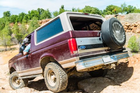 1996 Ford Bronco - This 1996 Ford Bronco is navigating a rocky off-road course with a driver at the wheel.