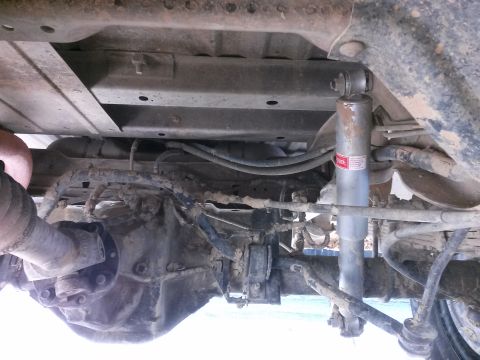 1996 Ford Bronco - The underside of a vehicle, revealing its rear axle and suspension components.