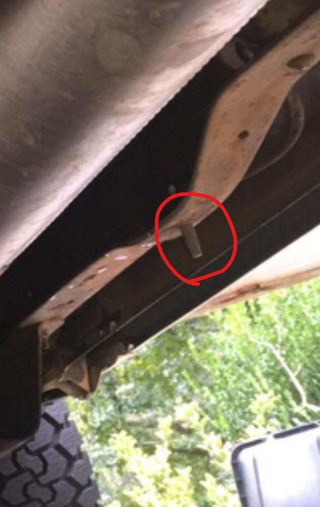 1988 Ford Bronco undercarriage, showing rusty frame and a red circle around a metal clip
