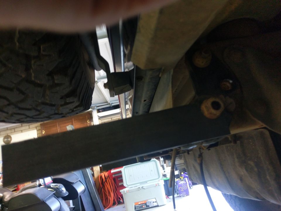 Undercarriage view showing spare tire and frame components