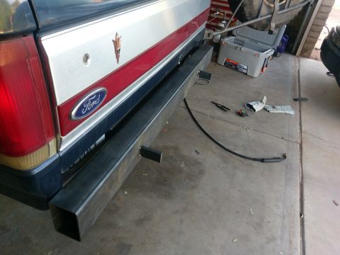1988 Ford Bronco - Custom steel rear bumper installation on a Ford Bronco, with tools and a cooler visible.