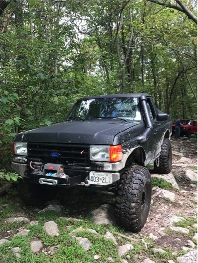 1989 Ford Bronco - Modified 1989 Ford Bronco navigating a wooded off-road course.
