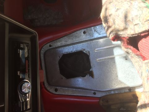 1986 Ford Bronco - Interior view of a vehicle's cabin, showing a JVC stereo and an exposed metal panel with a central opening.