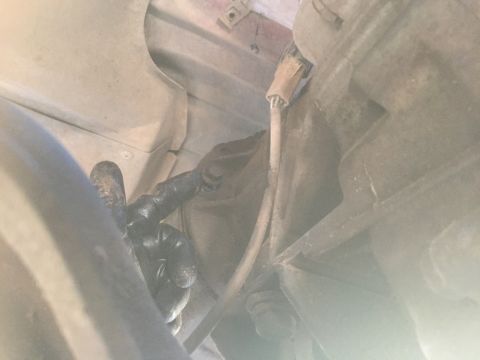 1986 Ford Bronco - A gloved hand points to an unidentified component on the underbody of a vehicle. The Supermotors.net logo is visible in the lower right cor…