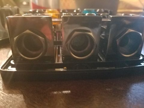 1994 Ford Bronco - A close-up view of a black fuse box with several terminals visible.