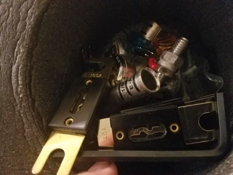 1994 Ford Bronco - A collection of automotive electrical components, including fuses and connectors, are visible in this close-up view.