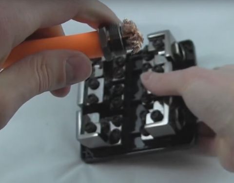 1994 Ford Bronco - Connecting an orange cable to a wiring terminal block.