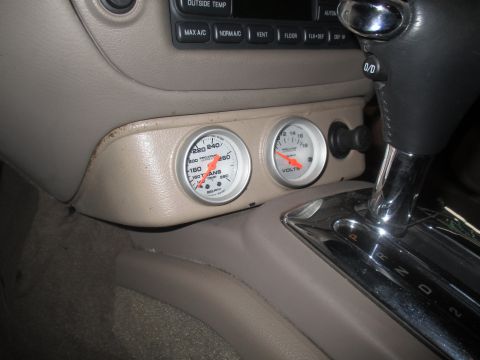 2004 Ford Crown Victoria - Aftermarket gauges are installed in the center console of this vehicle, showing transmission temperature and voltage.