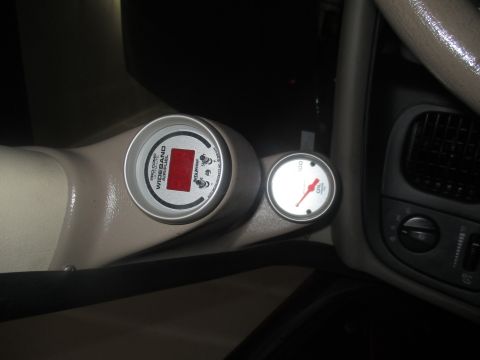 2004 Ford Crown Victoria - Custom gauges are installed in the vehicle's interior, showing air/fuel ratio and oil pressure.