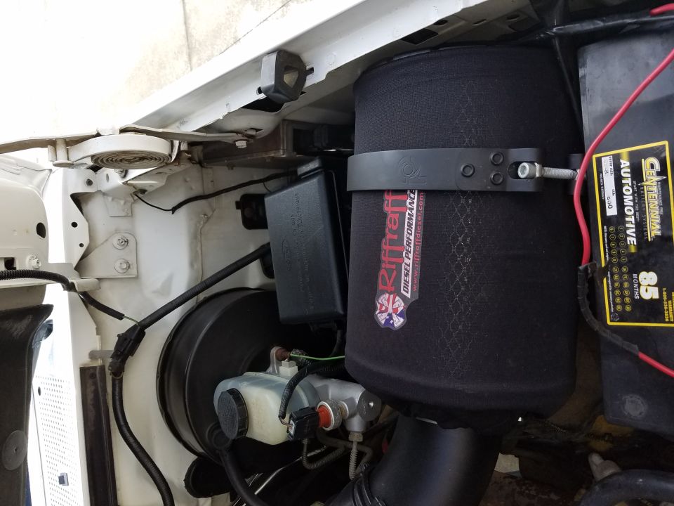Black Riff Raff Diesel cone air filter in engine bay beside Centennial battery and white fender