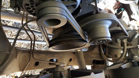 1978 Ford Bronco - Close-up view of engine belt pulleys and belts.