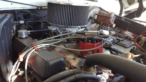 1978 Ford Bronco - Close-up view of a modified engine bay, showing various components and wiring.