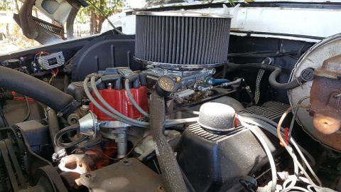 1978 Ford Bronco - Close-up view of an engine bay an aftermarket air filter and carburetor setup.