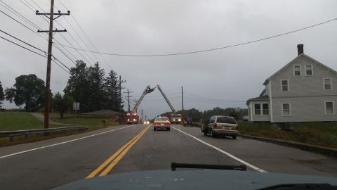 1991 Ford Crown Victoria - Emergency vehicles are present on a road with a taxi and a minivan, under an overcast sky.