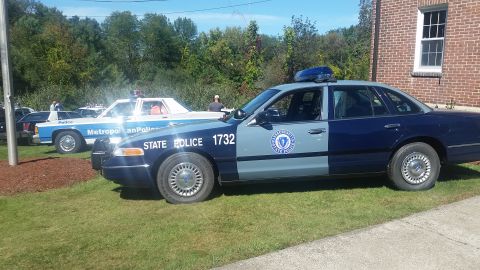 1991 Ford LTD Crown Victoria - A Massachusetts State Police car, number 1732, is parked on grass next to another police vehicle.