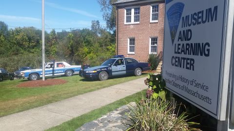 1991 Ford LTD Crown Victoria - Police vehicles are parked on the lawn in front of the Massachusetts State Police Museum and Learning Center.