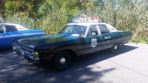 1991 Ford LTD Crown Victoria - A vintage police car, marked "MCY PCT #2", is parked next to another police vehicle.