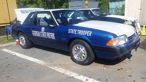 1991 Ford LTD Crown Victoria - A 1991 Ford Mustang police car is parked next to another vehicle.