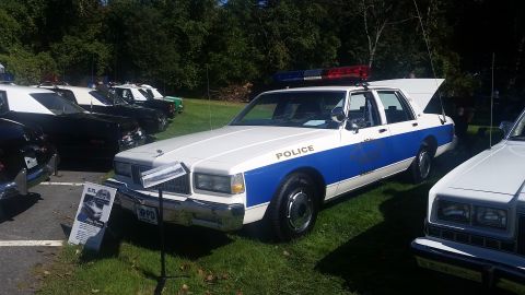 1991 Ford LTD Crown Victoria - This 1991 Ford Crown Victoria police car is displayed with other vehicles on a sunny day.