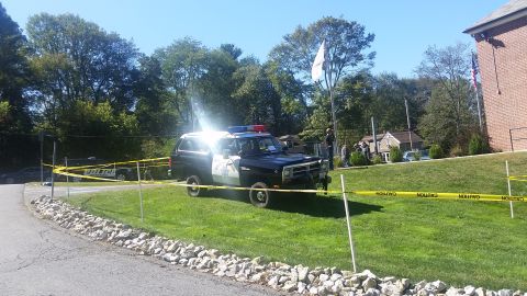 1991 Ford LTD Crown Victoria - A police SUV is parked on a grassy area, cordoned off with caution tape.