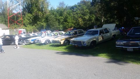 1991 Ford LTD Crown Victoria - Several vintage police cars are lined up on display, including a 1977 model with 'STATE POLICE' markings on the door.
