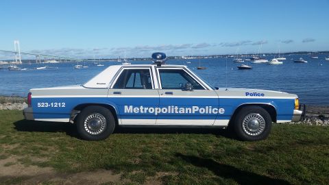 1991 Ford LTD Crown Victoria - A 1991 Ford Crown Victoria police car is parked by the water, displaying "Metropolitan Police" on its side.