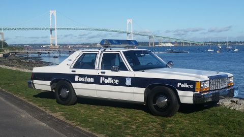 1991 Ford LTD Crown Victoria - Boston Police Crown Victoria parked by the water with a large bridge in the distance.