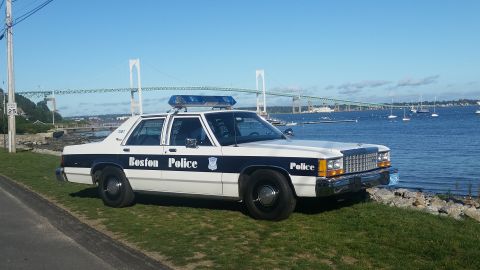 1991 Ford LTD Crown Victoria - Boston Police Crown Victoria parked by the water with a bridge in the background.