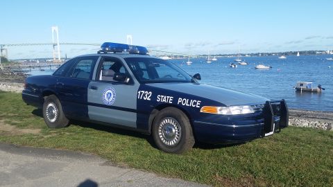 1991 Ford LTD Crown Victoria - This 1991 Ford Crown Victoria police car is parked by the water with a bridge in the background.