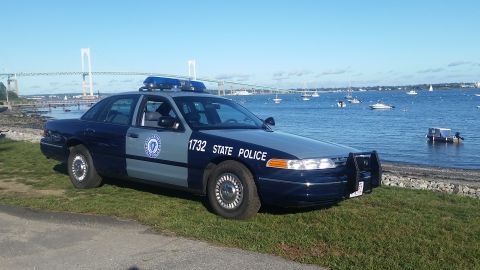 1991 Ford LTD Crown Victoria - 1991 Ford Crown Victoria police car with 'STATE POLICE' markings parked by the water.