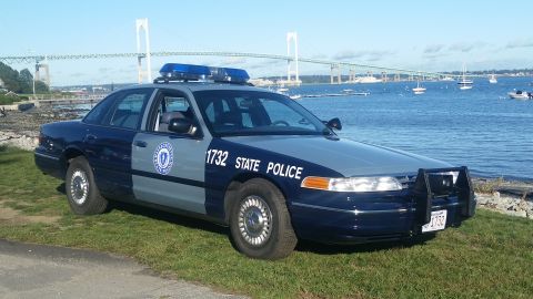 1991 Ford LTD Crown Victoria - 1991 Ford Crown Victoria police car, marked 1732 STATE POLICE, parked near a bridge and bay.