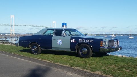 1991 Ford LTD Crown Victoria - Massachusetts State Police car with "STATE POLICE" text and number 678 visible.