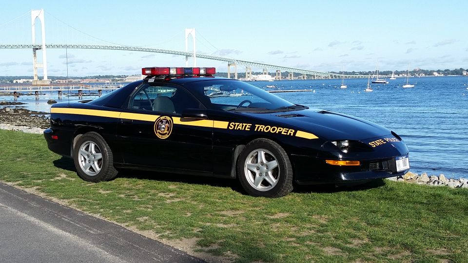 Black police car with yellow stripe and "STATE TROOPER" text, 1997 model