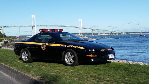 1991 Ford LTD Crown Victoria - State trooper car parked near a bridge and the water.