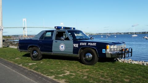 1991 Ford LTD Crown Victoria - Massachusetts State Police Crown Victoria parked waterside with a bridge and sailboats visible.