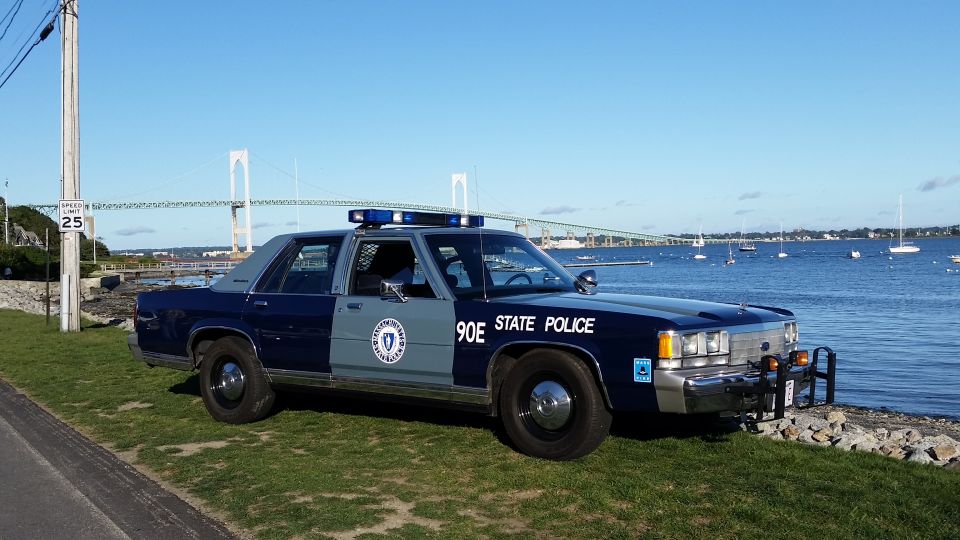 1991 Ford Crown Victoria police car, 3/4 front view, parked by water