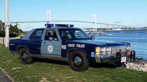 1991 Ford LTD Crown Victoria - This 1991 Ford Crown Victoria police car is parked by the water with a bridge in the background.